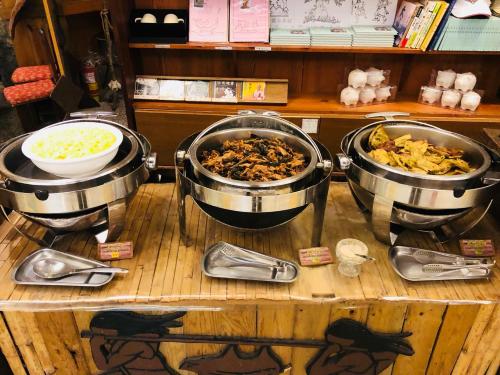 a wooden table topped with lots of different kinds of food at Taroko Village Hotel in Fushi