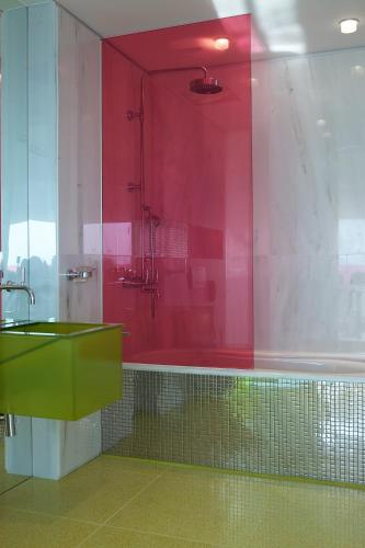 a bathroom with a green sink and a red wall at Semiramis in Athens