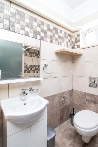 a bathroom with a sink and a toilet at Toulas Studios & Apts No2 in Faliraki