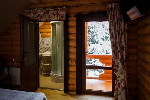 a bedroom with a door open to a porch at Provintsia in Migovo