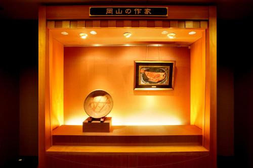 a clock in a display case in a room at Okayama Koraku Hotel in Okayama