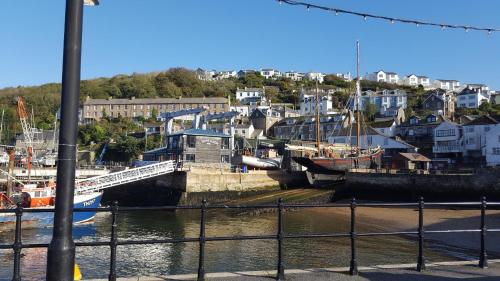 a marina with boats in the water and buildings at Polmarine in Polruan
