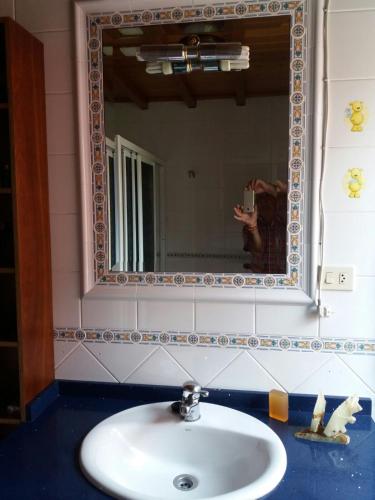 a person taking a picture of a sink in a bathroom at Casa Socorro in A Estrada