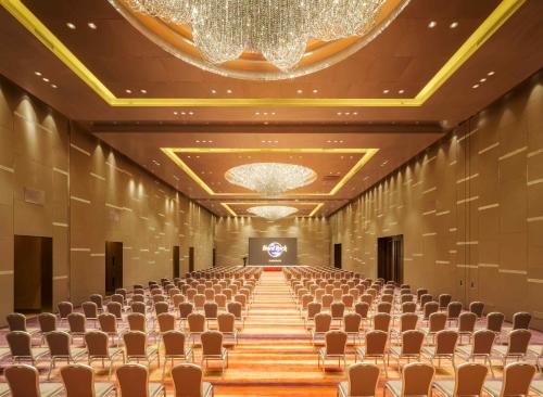 an empty conference hall with chairs and a chandelier at Hard Rock Hotel Shenzhen in Shenzhen