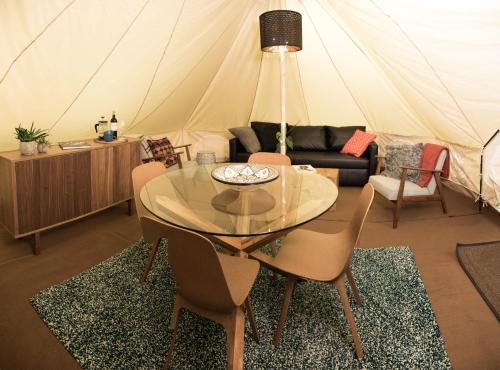 a dining table and chairs in a tent at Camp Boutique in Gaulverjabær