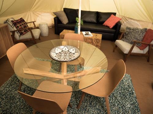 a living room with a glass table and chairs at Camp Boutique in Gaulverjabær