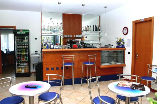 a kitchen with a table, chairs and a refrigerator at Hotel Casa Chincarini in Malcesine