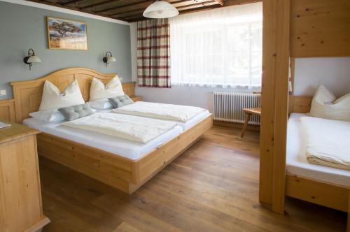 a bedroom with two bunk beds and a window at Bauernhof Kasleitner in Zell am Moos