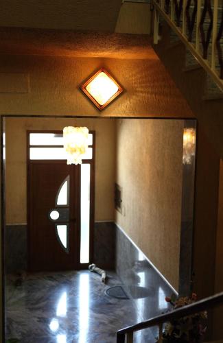 a hallway with a door with a mirror and a light at Il Cavaliere in Trapani