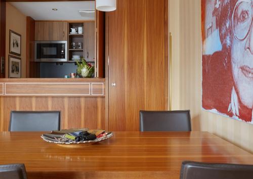 a table with chairs and a plate on top of it at Living Hotel an der Oper in Vienna