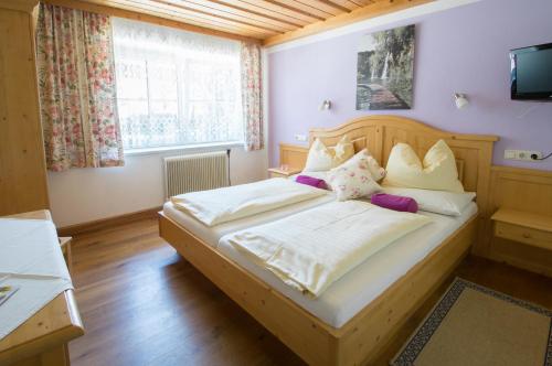 a bedroom with two beds and a television in it at Bauernhof Kasleitner in Zell am Moos