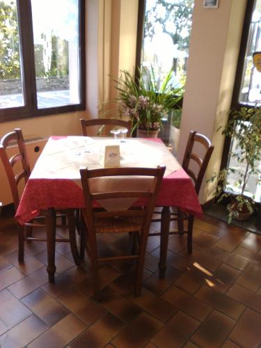 a dining room table with a red table cloth on it at Il Vapore in Oggebbio