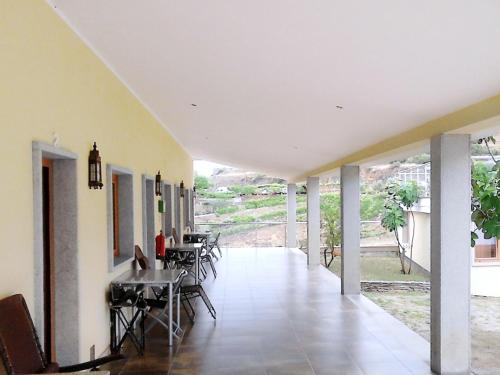 a hallway of a house with tables and chairs at Quintas do Valbom e Cuco in Torre de Moncorvo