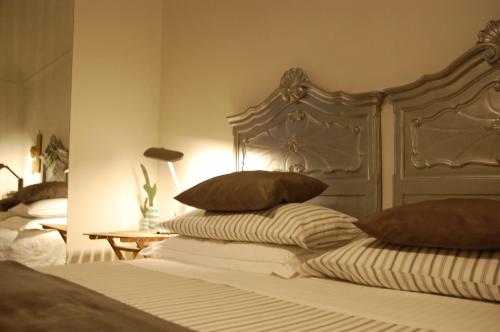 a bedroom with a bed with two pillows on it at Virginias B&B in Savona