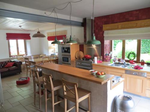 a kitchen with a large island in the middle at les maisons blanches in Weris