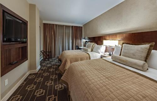 a hotel room with two beds and a flat screen tv at Wyndham Garden Chinatown in New York