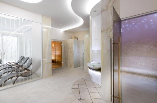 a bathroom with a shower and a toilet and chairs at Francis Palace in Františkovy Lázně