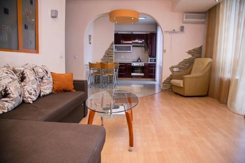 a living room with a couch and a glass table at Apartment.md in Chişinău