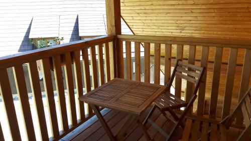 a wooden chair sitting on a porch of a cabin at Chata u Tří Sluk in Modrava