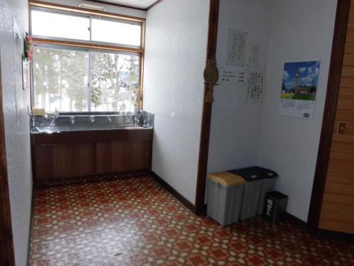 a bathroom with a sink and a window in a room at Morishigesou in Myoko