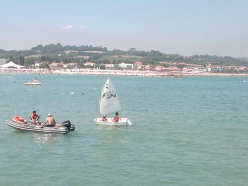 a group of people on small boats in the water at Lo Squero Rooms and Apartments in Fano