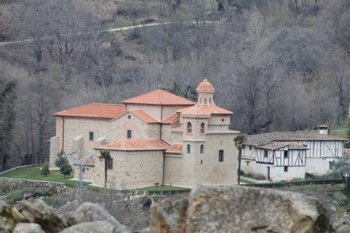 a large building with a tower on top of a hill at Casa Rural Luna in Candeleda