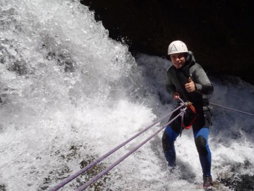a man is holding a rope while standing in a river at Casa Rural Luna in Candeleda