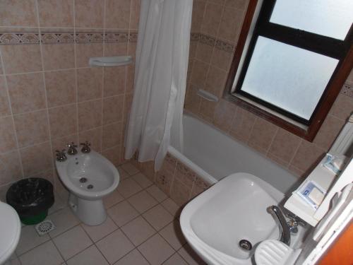 a bathroom with a sink and a toilet at Hotel Antartida Argentina in Ushuaia