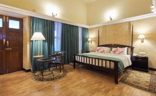 A bed or beds in a room at Royal Orchid Metropole Mysore