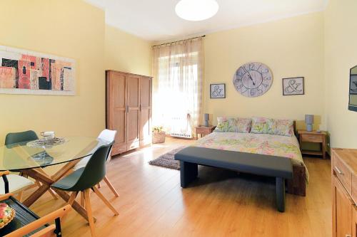 サッサリにあるLaCasadiAnita - Sassari - Sardegnaのベッドルーム(ベッド1台、テーブル、時計付)