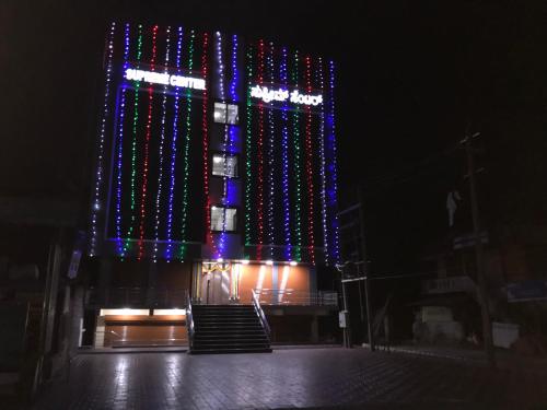 a building with christmas lights on it at night at SUPREME LODGe in Dharmastala