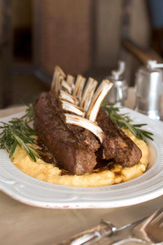 a piece of meat on a plate on a table at Hastings House Country House Hotel in Ganges
