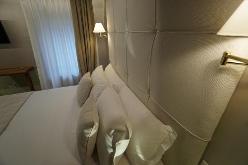 a bedroom with a bed with white pillows at P 1779 in Venice