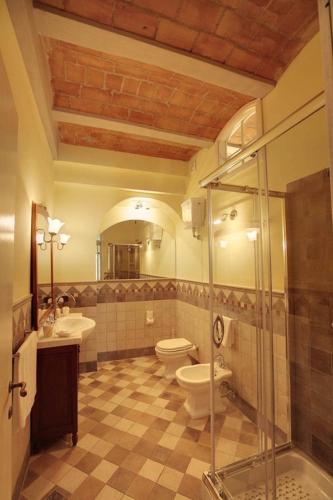 a bathroom with a shower and a toilet and a sink at Agriturismo Cannavota in Follonica