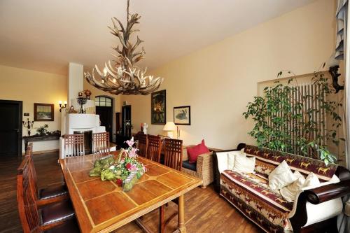 a living room with a table and a couch at Schlosshotel Bredenfelde in Bredenfelde