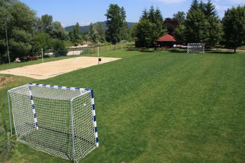 a fenced in field with a goal in a park at B&B Pri Peclju in Podgrad