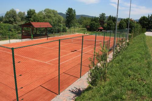 a tennis court with a gazebo in the background at B&B Pri Peclju in Podgrad