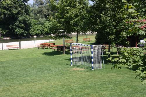 a gate in a park with picnic tables and benches at B&B Pri Peclju in Podgrad