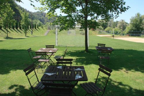 a group of picnic tables and chairs in a park at B&B Pri Peclju in Podgrad