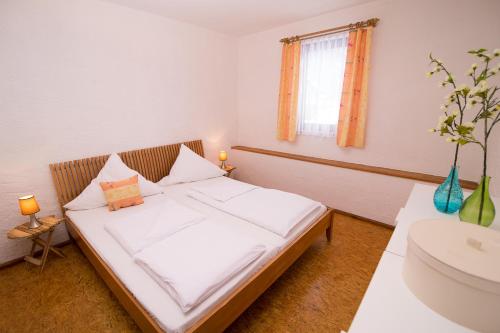 a bedroom with a bed and a sink in it at Thomasmühle Ferienwohnungen in Leutershausen