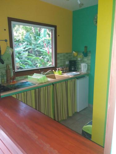 a kitchen with a sink and a window at Ti Plèn Kréol in Pointe-Noire