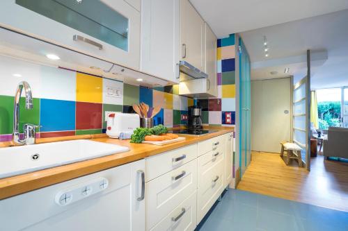 a kitchen with colorful tiles on the wall at Friendly Rentals Olimpic Beach in Barcelona