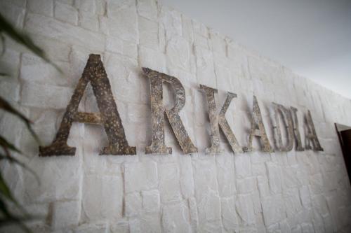 a sign on the side of a brick building at Hotel & Spa Arkadia in Tomaszów Lubelski