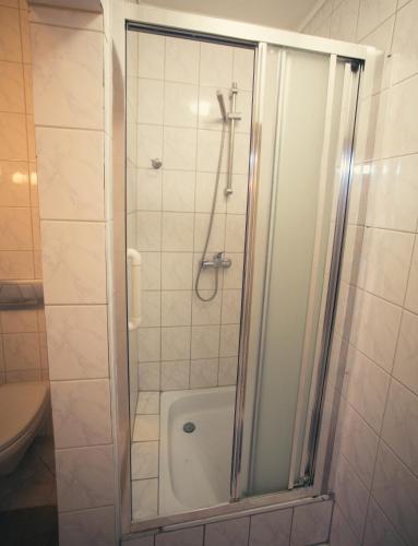 a shower with a glass door in a bathroom at Hotel & Spa Arkadia in Tomaszów Lubelski