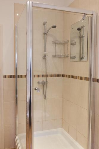 a shower with a glass door in a bathroom at Apartment 3 The Grove in Durham