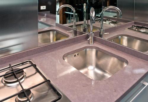 a kitchen with a stainless steel sink and a stove at altana san marco in Venice