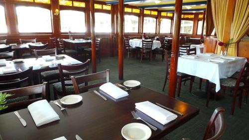 a restaurant with tables and chairs with white napkins at Delta King Hotel in Sacramento