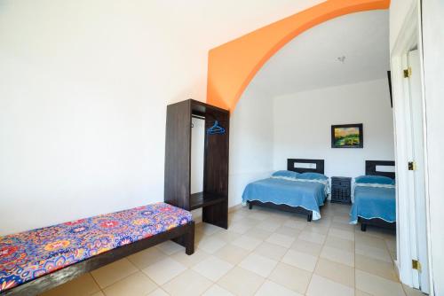 a hospital room with two beds and an archway at Mirador del Castillo in Tenexcalco
