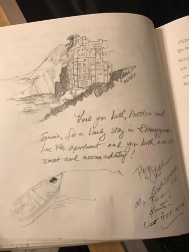 a page of a book with a drawing of a city at Rifugio dei Pescatori in Riomaggiore
