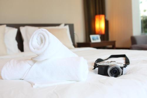 a camera sitting on top of a bed at AnB-Glass House pool villa-3BR close to Jomtien beach in Na Jomtien